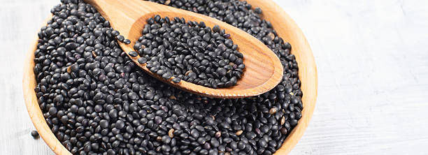 istock Black beluga lentil seeds in a plate. 2211899995