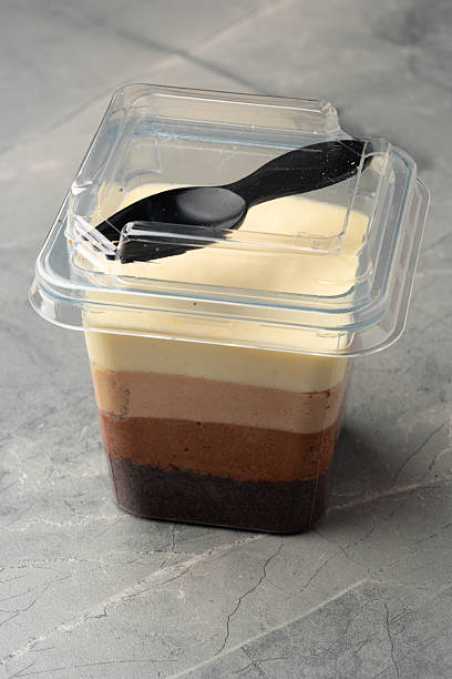 istock Layered dessert in a clear container with a plastic spoon resting on top 2211900163