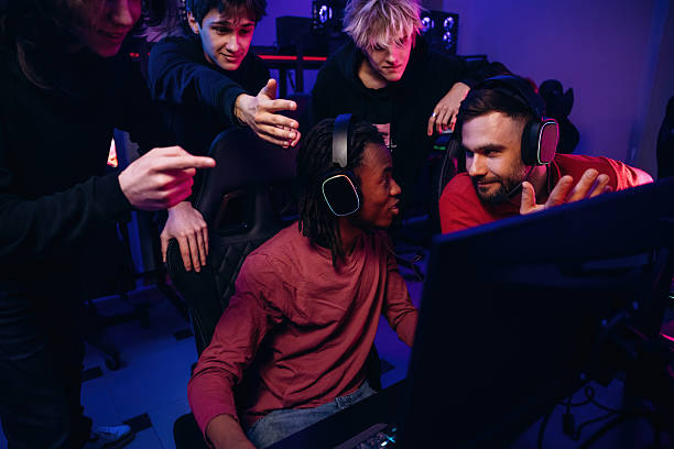 istock Watching and learning. Gamers are playing video game by computers 2211900326
