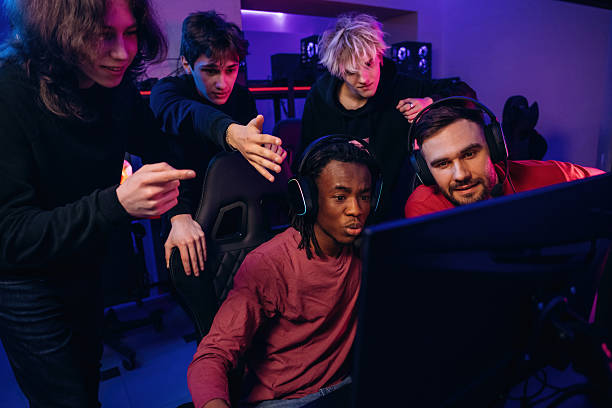 istock Watching and learning. Gamers are playing video game by computers 2211900339