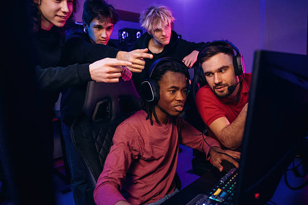 istock Watching and learning. Gamers are playing video game by computers 2211900340