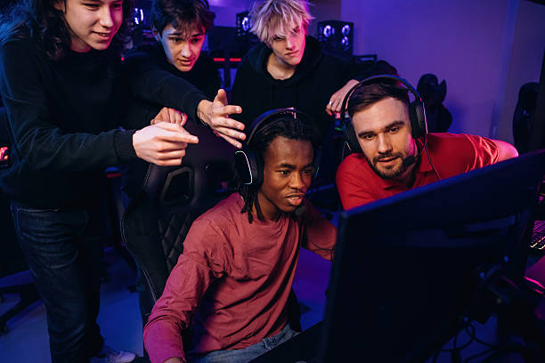 istock Watching and learning. Gamers are playing video game by computers 2211900349