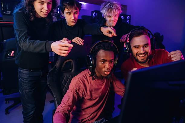 istock Watching and learning. Gamers are playing video game by computers 2211900350