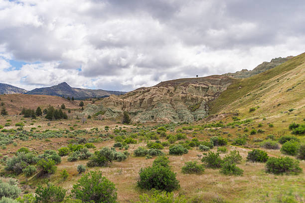 Majestic mountains of Armenia under a blue sky filled with clouds, showcasing natural beauty and rugged terrain