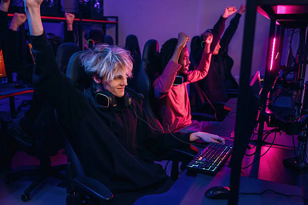 istock Celebrating victory. Gamers are playing video game by computers 2211900505