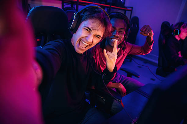 istock Selfie time. Gamers are playing video game by computers 2211900591