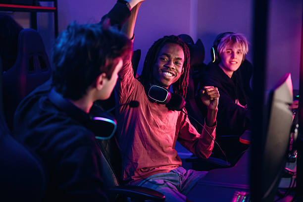 istock Team has won. Gamers are playing video game by computers 2211900670