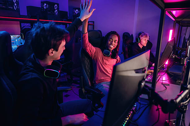 istock Team has won. Gamers are playing video game by computers 2211900676