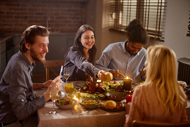 istock Happy diverse friends enjoying in lunch at dining table. 2211902768