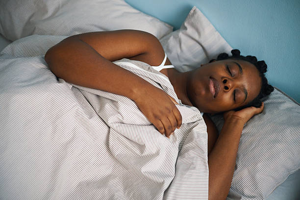 istock Sleeping African American Woman in Comfortable Bed 2211904207