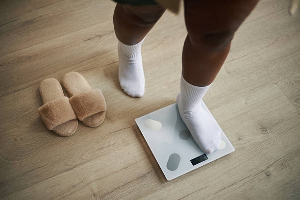 Standing on Digital Scale Wearing White Socks and House Slippers