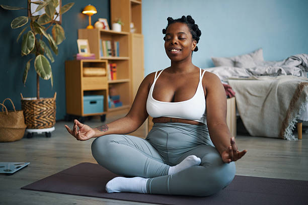istock Practicing Yoga at Home in Comforting Setup 2211904266