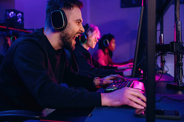 istock Using keyboard and mouse. Gamers are playing video game by computers 2211905790