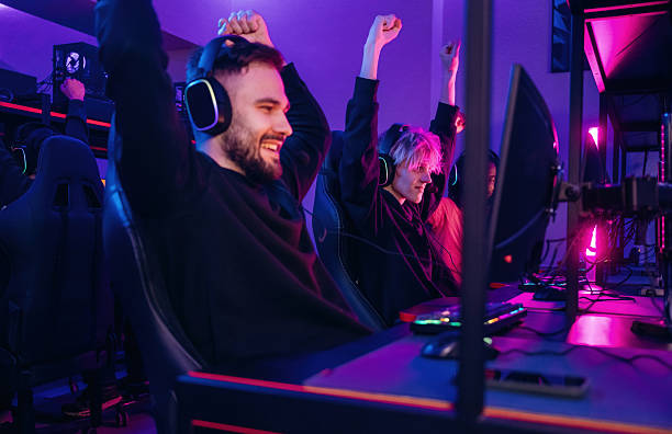 istock Team has won. Gamers are playing video game by computers 2211905791