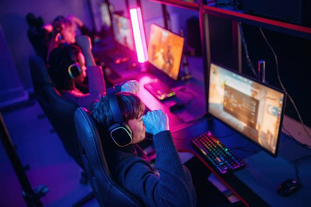 istock Shooter game. People are playing video game by computers 2211905854