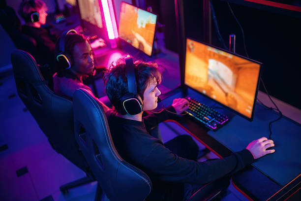 istock Shooter game. People are playing video game by computers 2211905938