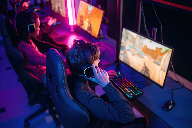 istock Shooter game. People are playing video game by computers 2211905941