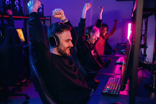 istock In headphones. Gamers are playing video game by computers 2211905943