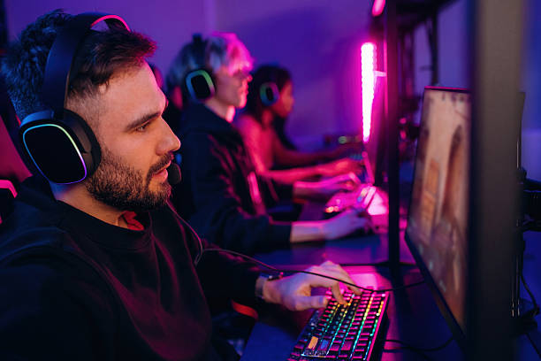 istock In headphones. Gamers are playing video game by computers 2211906086