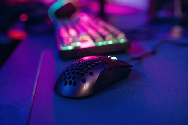 istock Colorful keyboard. Gaming computer is in the dark room with neon lighting 2211906168