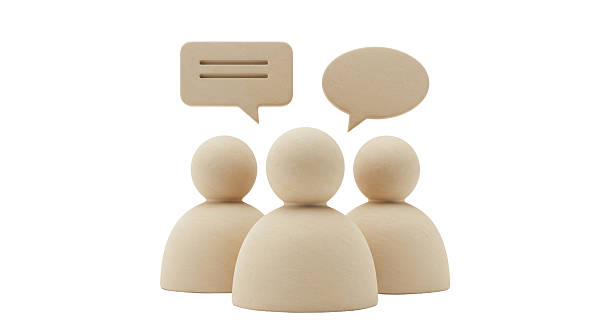 istock Isolated Three Wooden Figures Sharing Ideas Through Speech Bubbles 2211906269