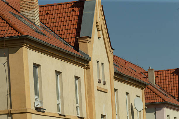 The enchanting architecture of a beautiful residential building is prominently showcased through its vibrant red tile roofs