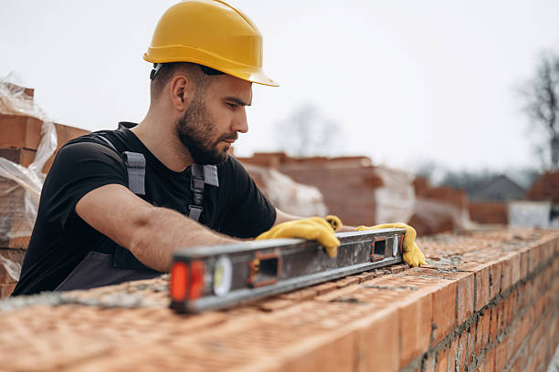 istock Using leveler tool. Construction worker is at job with bricks outdoors 2211910210