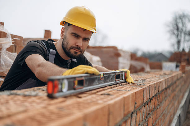 istock Using leveler tool. Construction worker is at job with bricks outdoors 2211910219