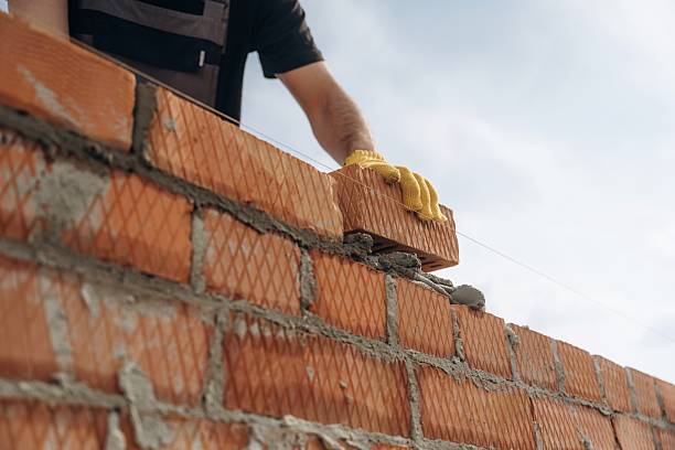 istock Making the wall. Close up view of construction man that is working with bricks 2211910359