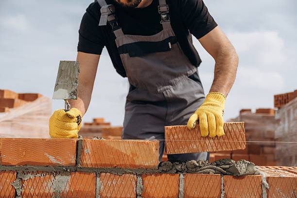 istock Creating the wall. Close up view of construction man that is working with bricks 2211910371