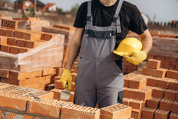 istock Holding hard hat. Close up view of construction man that is working with bricks 2211910415