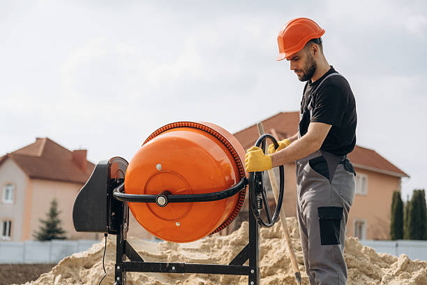 istock Man is working on the construction site with concrete mixer 2211910649