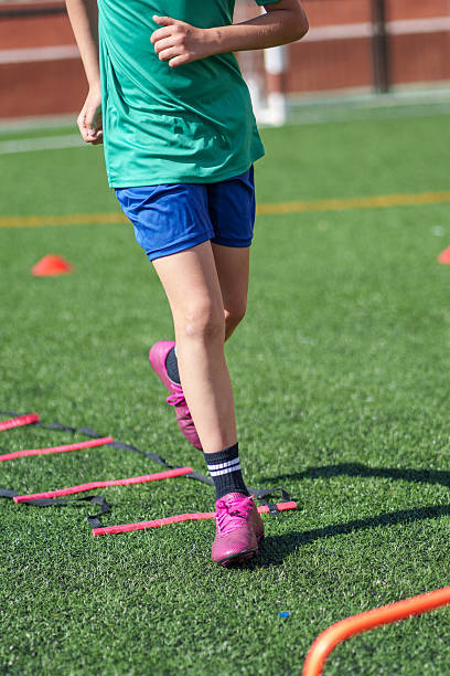 istock Young soccer player practicing agility drills on turf field 2211910804