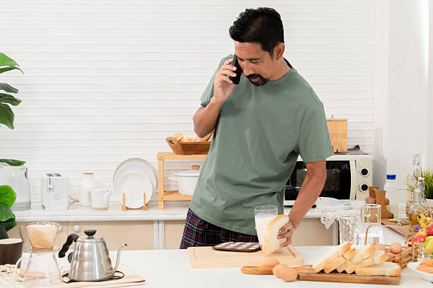 Creative professional multitask effortlessly as the morning sun, man focused gaze on laptop screen new project work from home, snapshot captures a modern lifestyle meets productive energy arrangement
