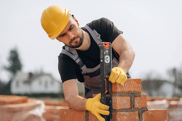 istock Setting up the right level with tool. Construction worker is at job with bricks outdoors 2211912619