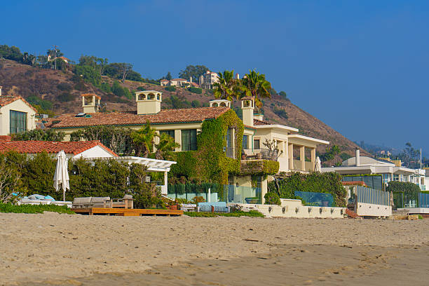 Malibu, California - December 21, 2024: Beauty of Malibu with stunning coastal homes nestled against the sandy beach and picturesque hills, perfect for vacations or relaxing retreats.