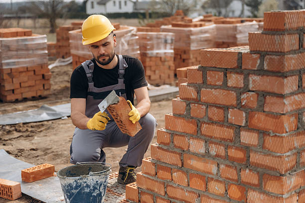 istock Busy by working with bricks. Construction worker is at job outdoors 2211912789