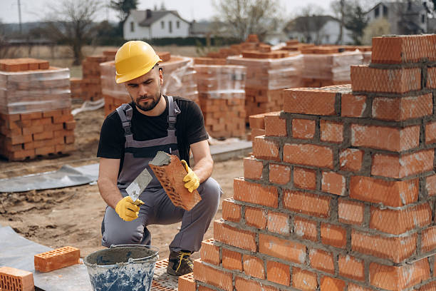 istock Busy by working with bricks. Construction worker is at job outdoors 2211912804