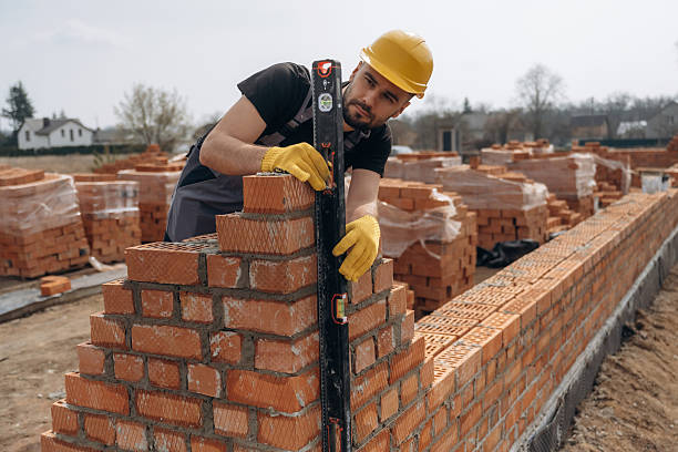 istock Black colored leveling tool. Construction worker is at job with bricks outdoors 2211912885