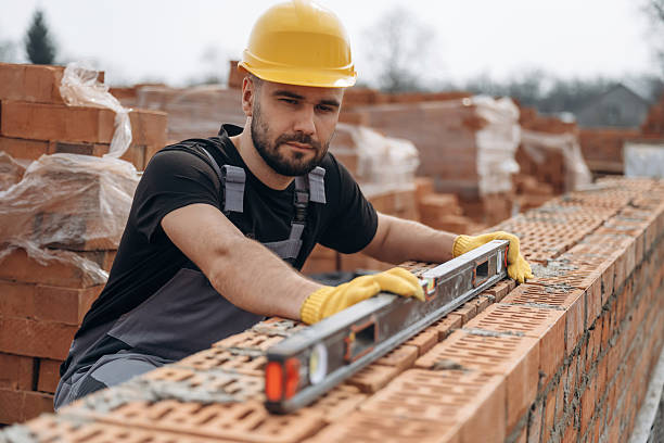 istock Setting up the right level with tool. Construction worker is at job with bricks outdoors 2211913056