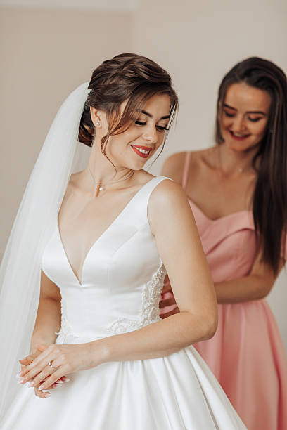 istock A bride is getting ready for her wedding with her bridesmaid 2211913257
