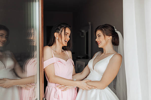 istock Two women are standing in front of a window 2211913276