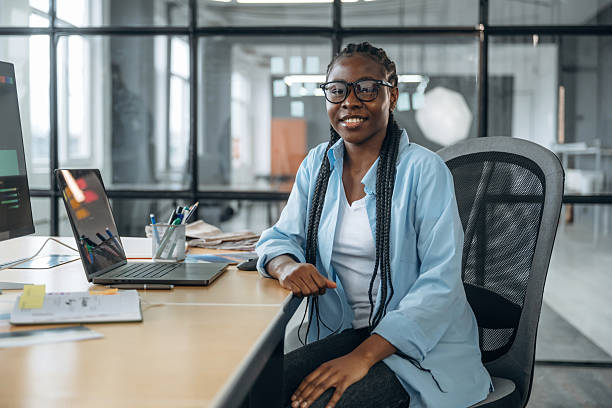 istock Toothy smile, sitting. Designer is working in the office 2211913991