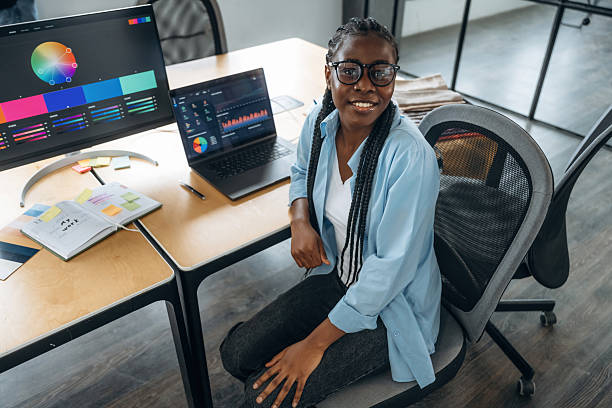istock Toothy smile, sitting. Designer is working in the office 2211914038