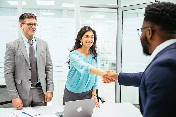 istock Multicultural corporate business people working in modern bright office and shaking hands after successful meeting 2211915176