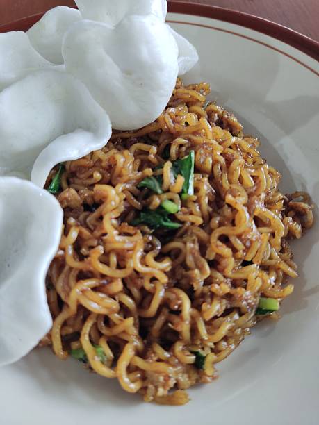Fried noodle tek-tek with onion cracker on plate Javanese Indonesian food
