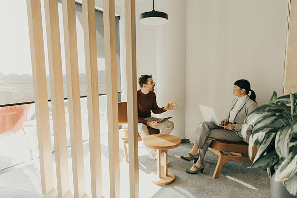istock Engaging discussion between colleagues in a bright modern workspace during afternoon hours 2211916655