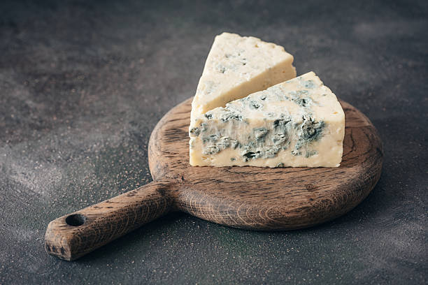 istock Blue cheese on a wooden round board close-up 2211917073