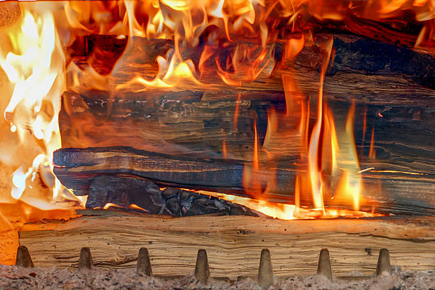 istock Burning Firewood Inside Open Stove – Cozy Fireplace, Rustic Heating, Warmth, Flame and Wood Concept for Home Comfort and Energy 2211920113