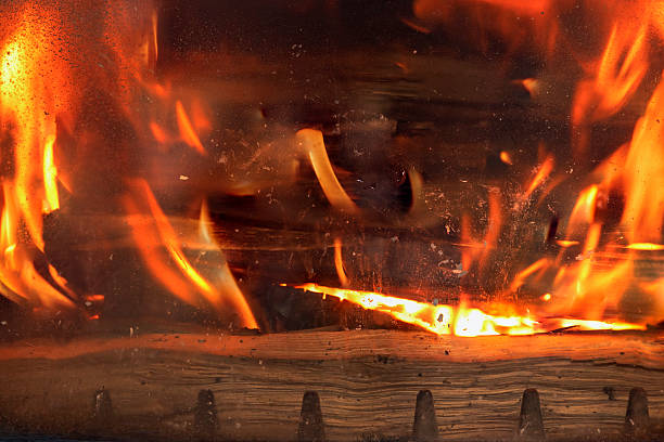 istock Burning Firewood Inside Open Stove – Cozy Fireplace, Rustic Heating, Warmth, Flame and Wood Concept for Home Comfort and Energy 2211920117